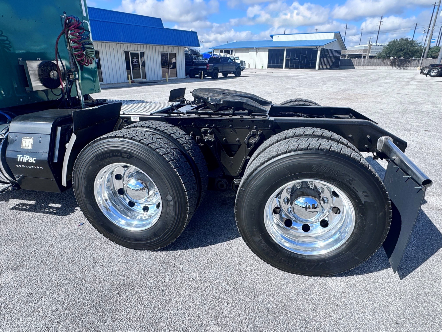 Kenworth W900L rear chassis with dual rear wheels and chrome wheels, rear fender and drivetrain area visible