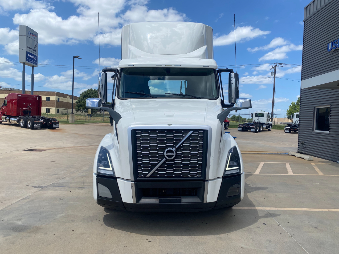 Volvo VNL300 conventional daycab front view showing grille, headlights, and Volvo emblem.