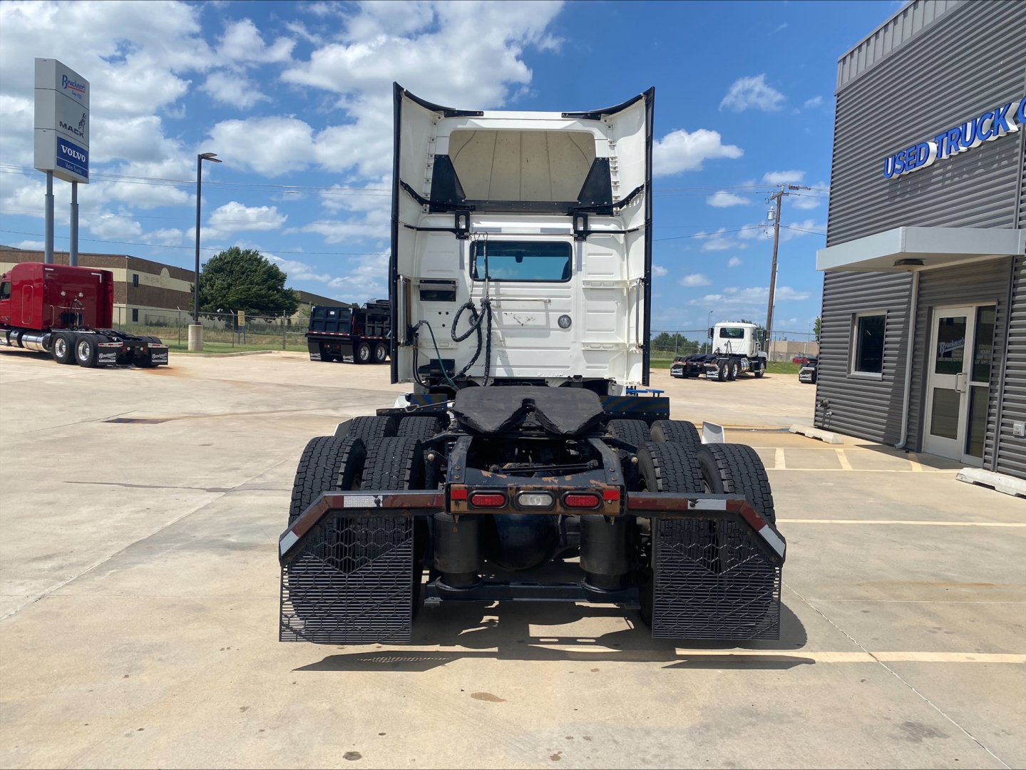 Rear view of a 2019 Volvo VNL300 truck tractor with fifth wheel and dual rear axles in a dealership lot.