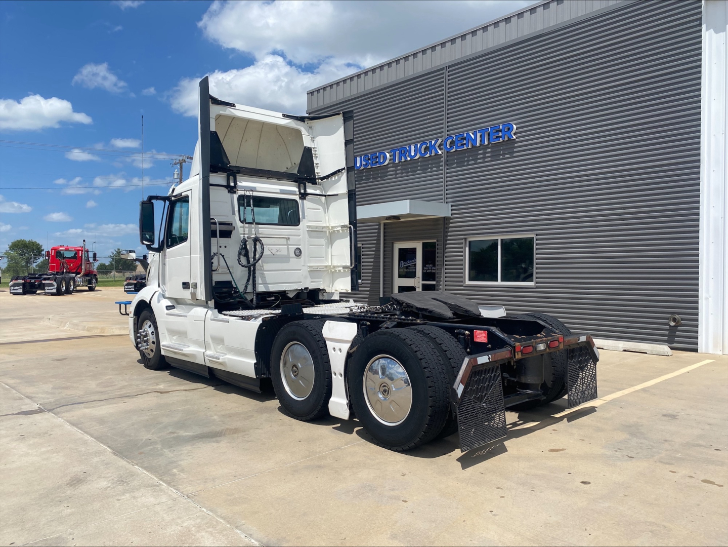 Volvo VNL300 tractor in off-bay view showing side and rear with raised sleeper cab and chassis, no trailer attached.