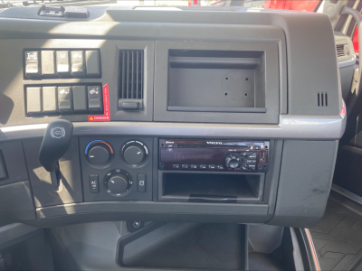 Cabin dashboard of a 2019 Volvo VNL300 showing climate controls, radio tuner, empty radio slot, and various switches.