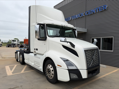 Volvo VNL300 tractor-trailer cab in front view with white exterior and large grille, docked at truck center.