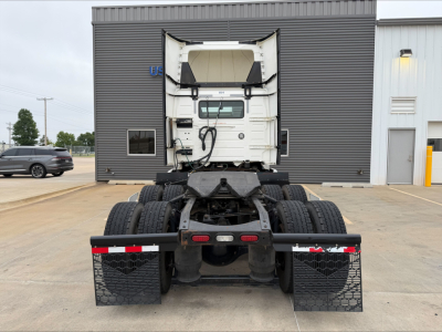 Rear view of a Volvo VNL300 truck tractor with fifth wheel and dual rear axles, showing the back of the cab and mud flaps.