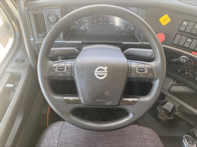 Volvo VNL300 truck cab interior showing steering wheel with Volvo logo and dashboard controls.
