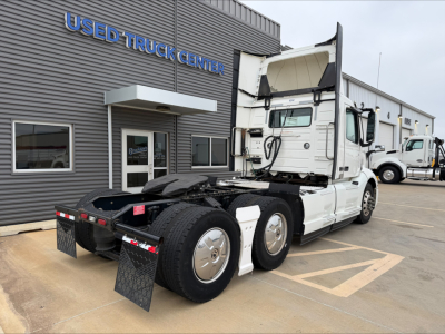 Volvo VNL300 tractor unit in a used truck lot showing rear view and cab interior open.