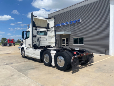 Volvo VNL300 tractor in off-bay view showing side and rear with raised sleeper cab and chassis, no trailer attached.
