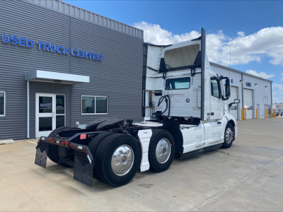 Volvo VNL300 truck in service showing daytime cab with raised sleeper and side view mirrors.