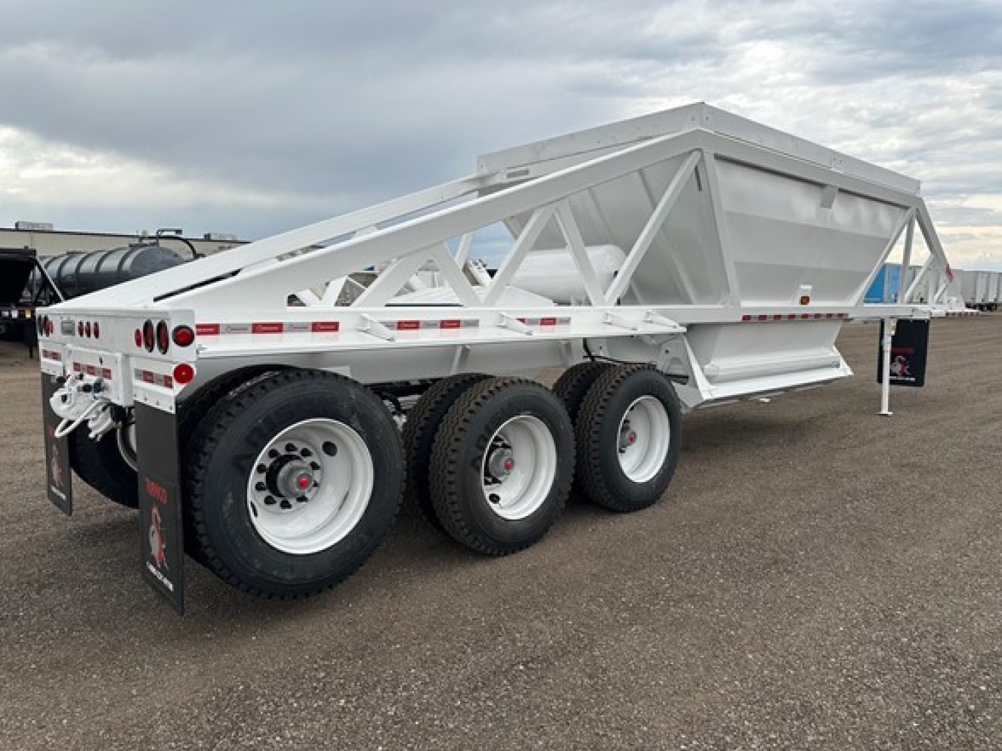 Ranco LW21-40-3 dump trailer showing triple axle with white painted frame and side-slung bed, rear hitch visible, stock number 192694.