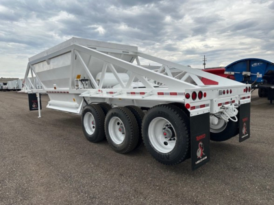 Dump trailer with white structural frame showing triple axle configuration and rear mudflaps. No visible labels or serials readable on side.