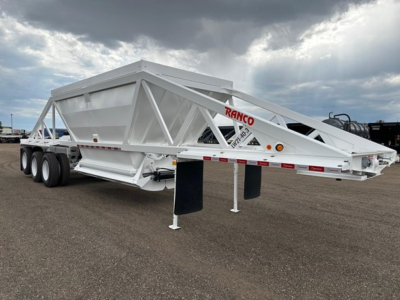 Ranco LW21-40-3 dump trailer on a flat lot showing long dual-axle chassis with white frame and red RANCO branding on the front rail.