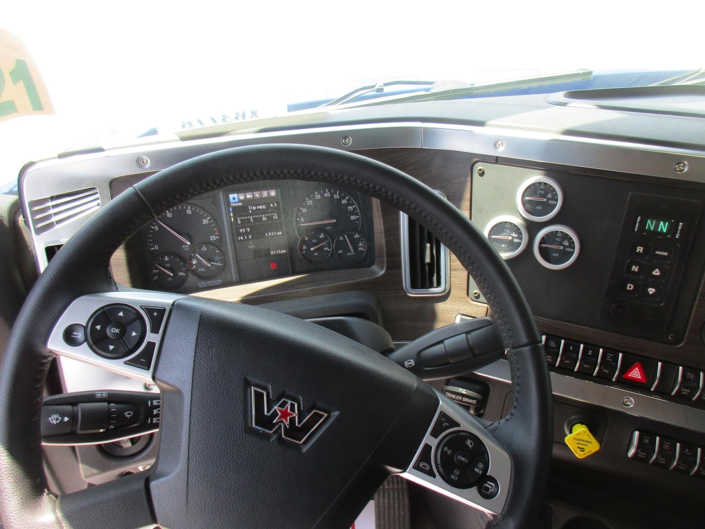 Dashboard and steering wheel view of a Western Star 49X cab with instrument cluster and control switches.
