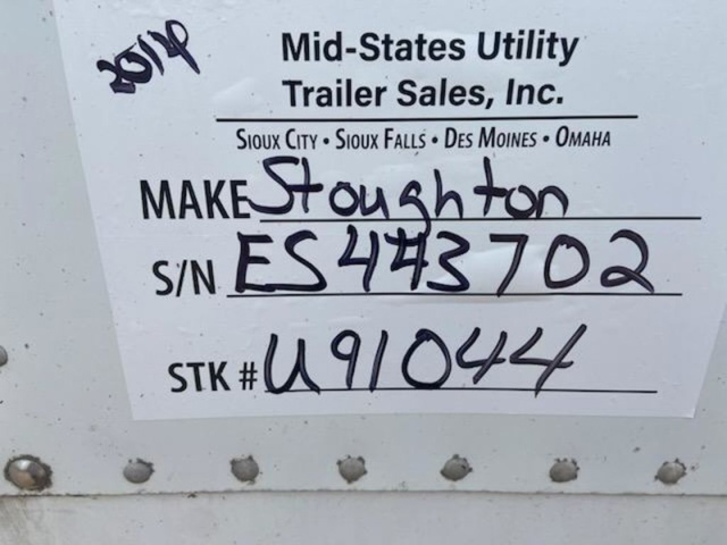 Tag on trailer showing dealer name and stock details: 'Mid-States Utility Trailer Sales, Inc.' with locations; handwritten: MAKE Stoughton; S/N ES474302; STK # U91044.