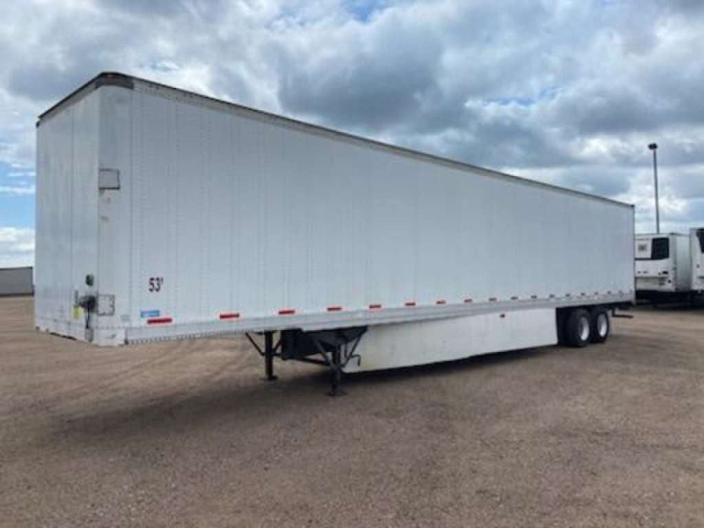 Trailer side view showing 53' Stoughton van trailer with dual rear axle and lander legs.