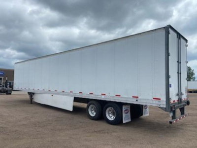 Trailer side view showing a white 2014 Stoughton van trailer with dual rear axles and a raised landing gear, no visible cab.