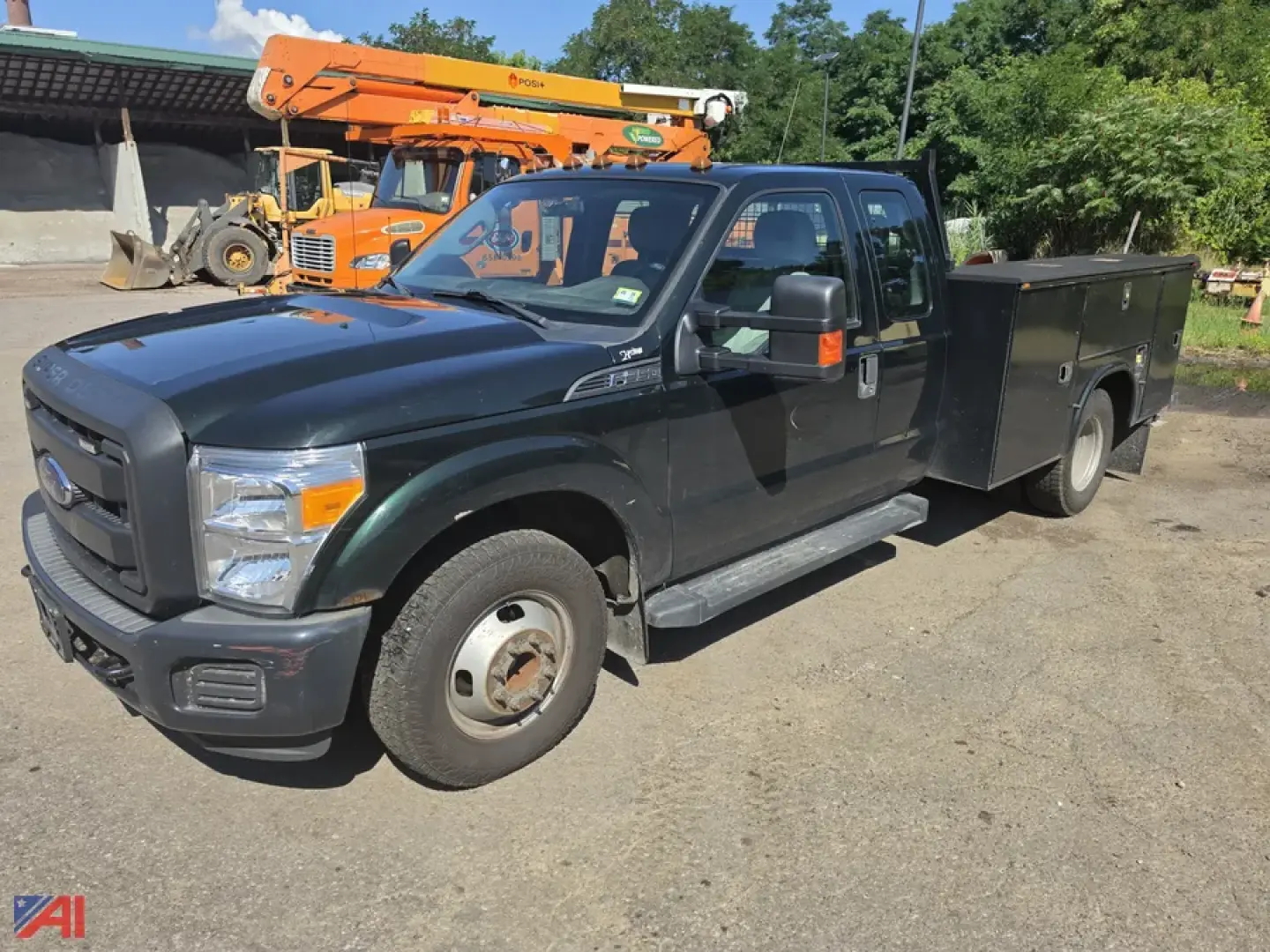 Ford F-350 Super Duty utility truck from the front-left side, dual cab, long service bed with toolbox, in a used condition.