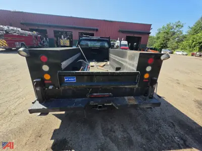 Truck bed of a Ford F-350 utility/service truck back view showing open cargo area and tail lights.