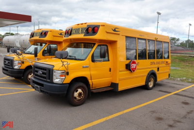 Ford Blue Bird school bus from side and front angle showing yellow school bus with stop sign extended and school bus markings.