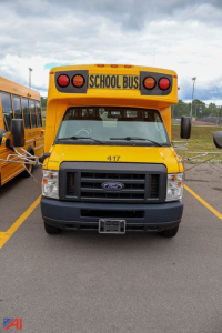 Ford E-series school bus front view showing yellow body, black grille, 417 number on hood, and ‘SCHOOL BUS’ sign on top.