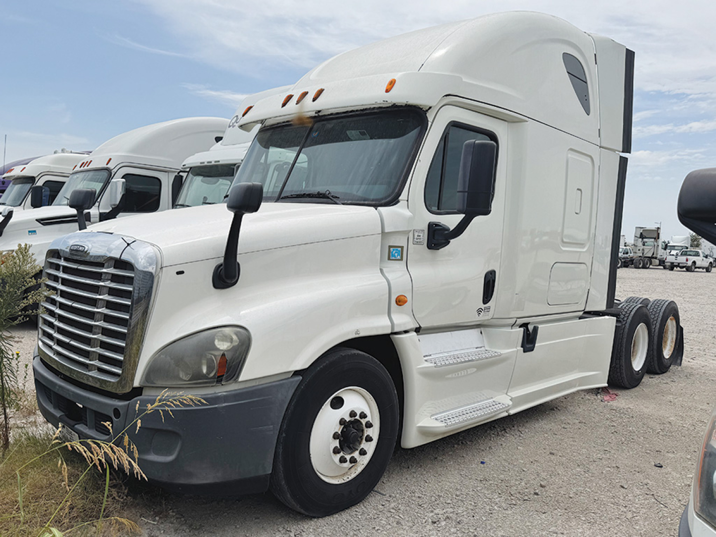 Truck: 2014 Freightliner Cascadia125 semi-truck with sleeper cab, white, front three-quarter view showing cab and 6 wheels on the drive axle; no visible text legible on vehicle badges.