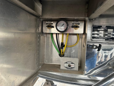 Mac polished all aluminum flatbed lift trailer control panel with gauge and wiring inside metal enclosure showing MAC label and ON/OFF light switch.