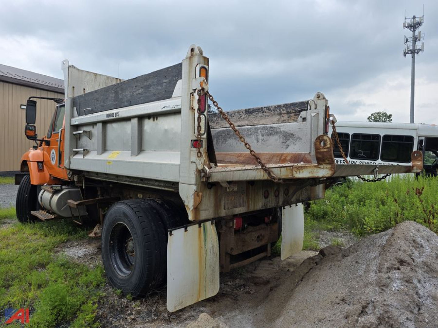Dump truck bed raised with rust and chains, rear view showing tailgate and mud flaps on a used 2008 International WorkStar 7500 dump truck.