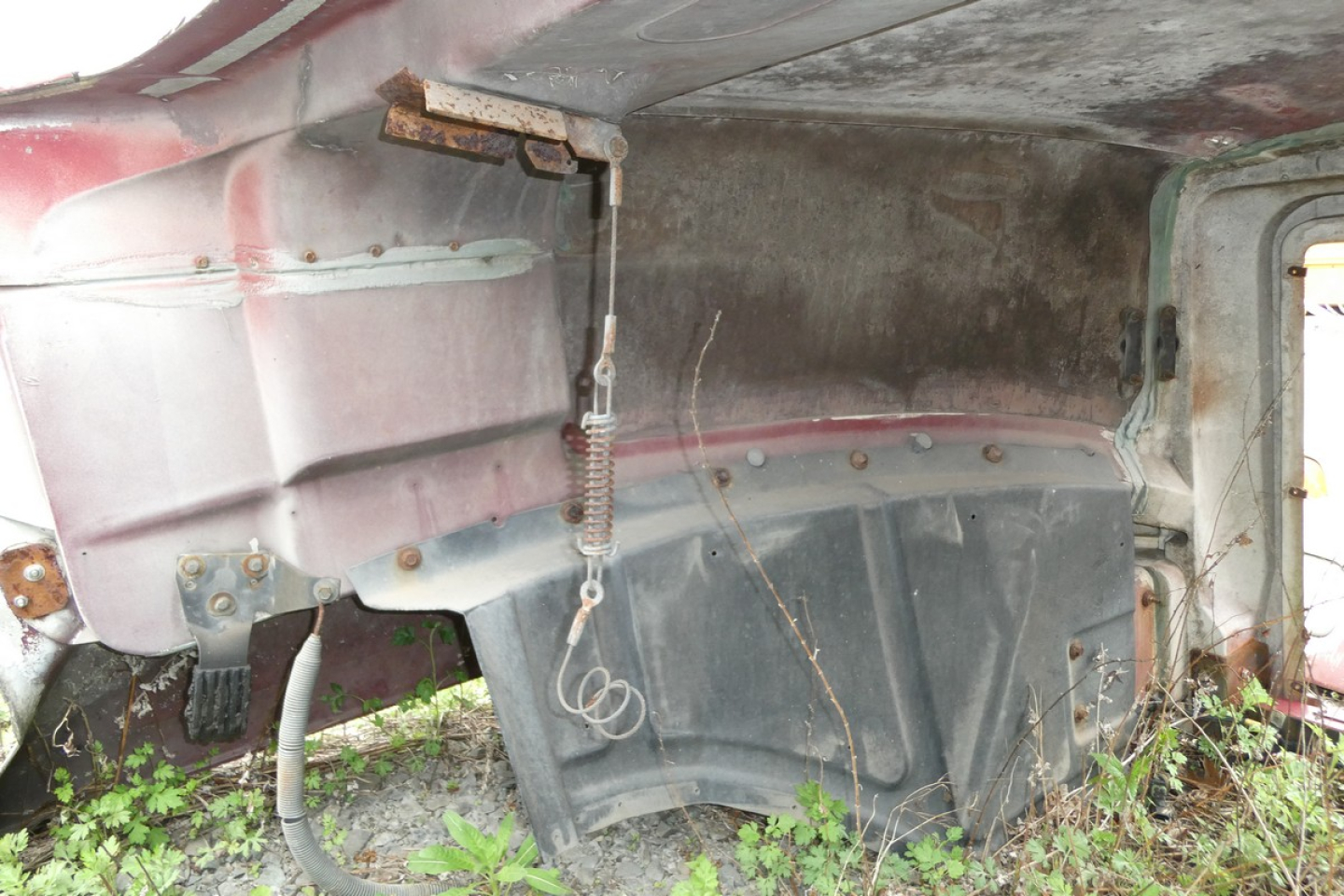 Mack CH612 hood component view showing exterior body panels and mounting hardware with overhanging hood edge and spring latch.