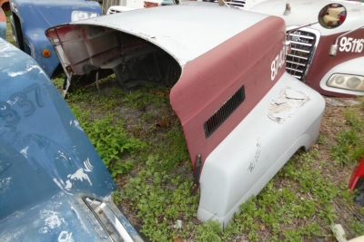 Mack CH612 hood assembly panels parked outdoors with red and white paint, side vent area, and visible part numbers.