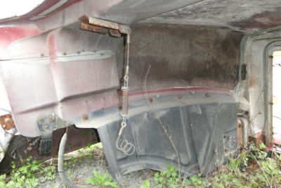 Mack CH612 hood component view showing exterior body panels and mounting hardware with overhanging hood edge and spring latch.