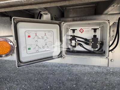 Trailer utility panel open showing hydraulic/electrical fittings and schematic diagram inside door panel on a 2019 Reitnouer dropdeck trailer.