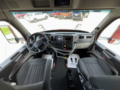 Peterbilt 579 cab interior showing dashboard, steering wheel, and front seats.
