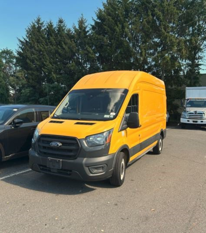 Ford Transit cargo van 2020 in yellow, front three-quarter view, showing cab chassis truck with high roof and black grille