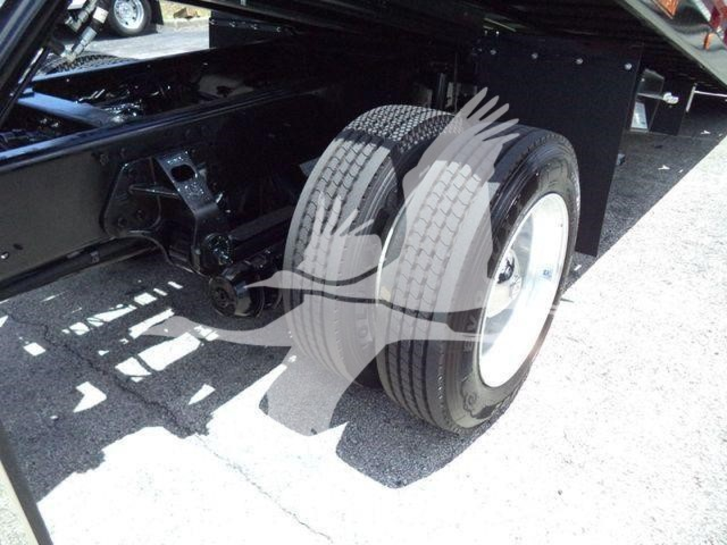 Truck rear dual tires and undercarriage of a 2020 Hino 268A rollback truck showing dual rear wheels and chassis components.