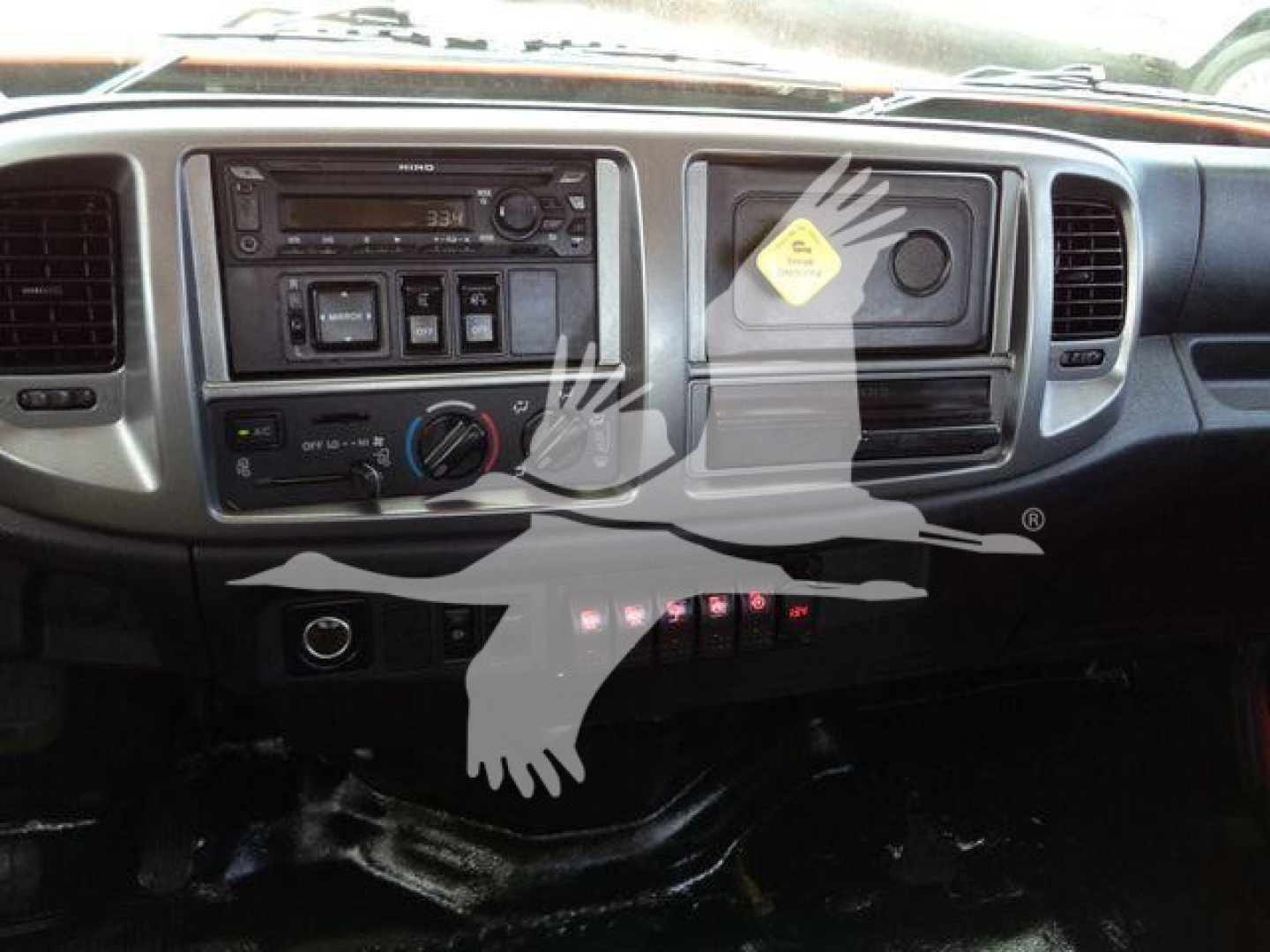 Dashboard of a 2020 Hino 268A rollback truck showing center console and steering wheel area.