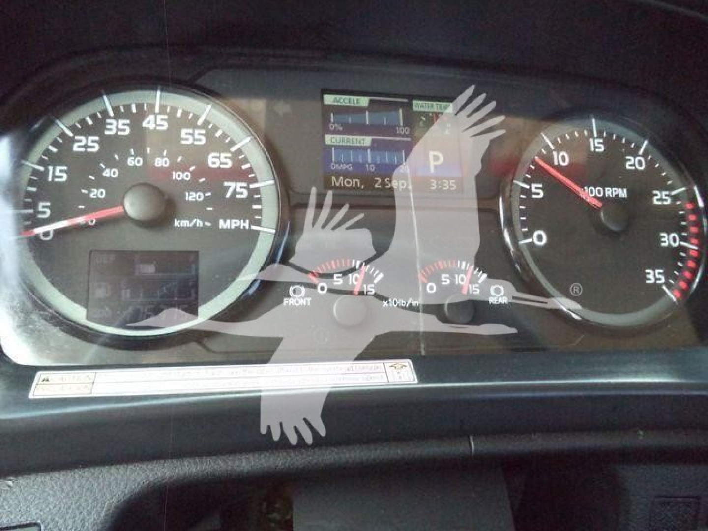 Hino 268A dashboard showing speedometer, tachometer, and digital display with various readouts in instrument cluster.