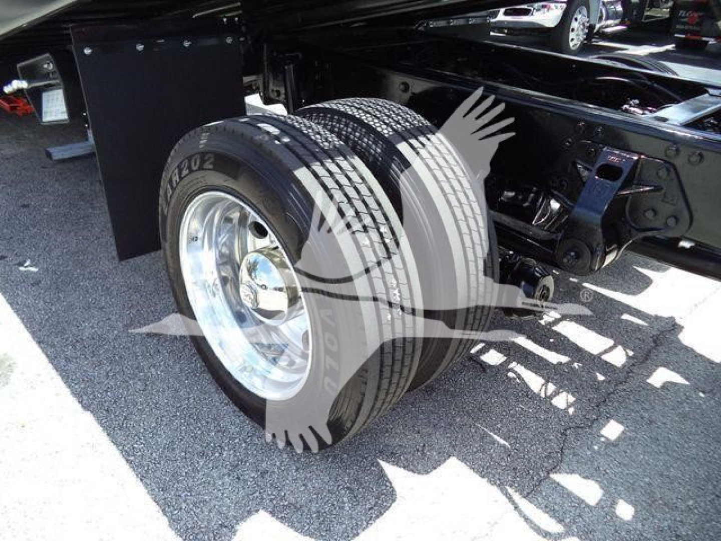 Hino 268A truck rear wheel area showing dual rear tires and suspension components.