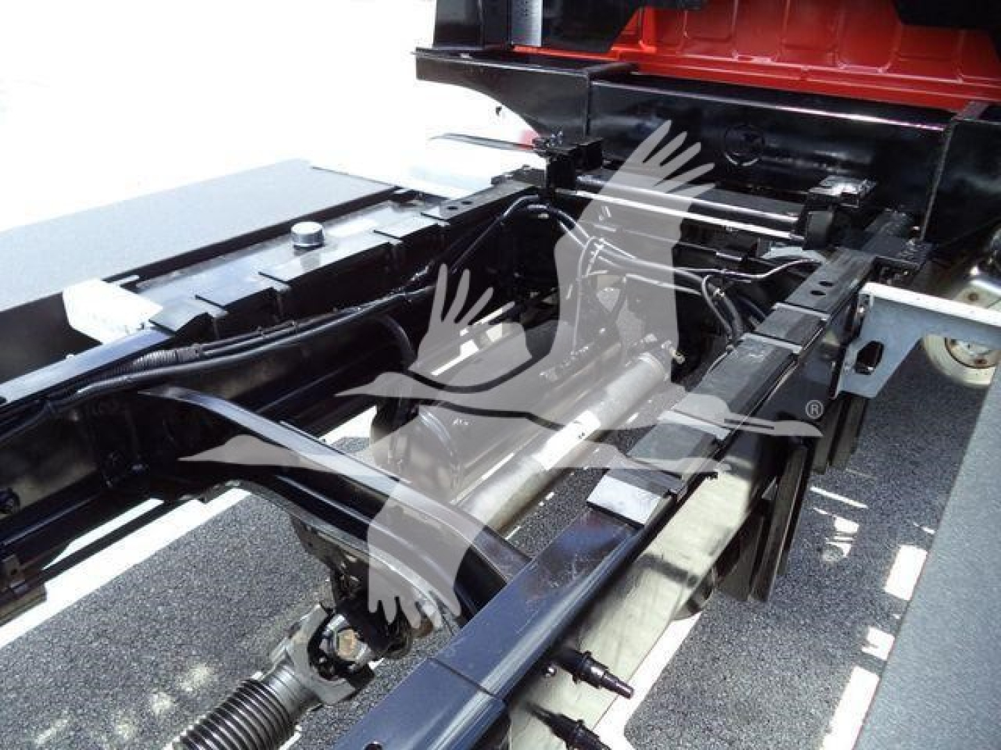 Hino 268A truck chassis showing frame rails and suspension components from side view.