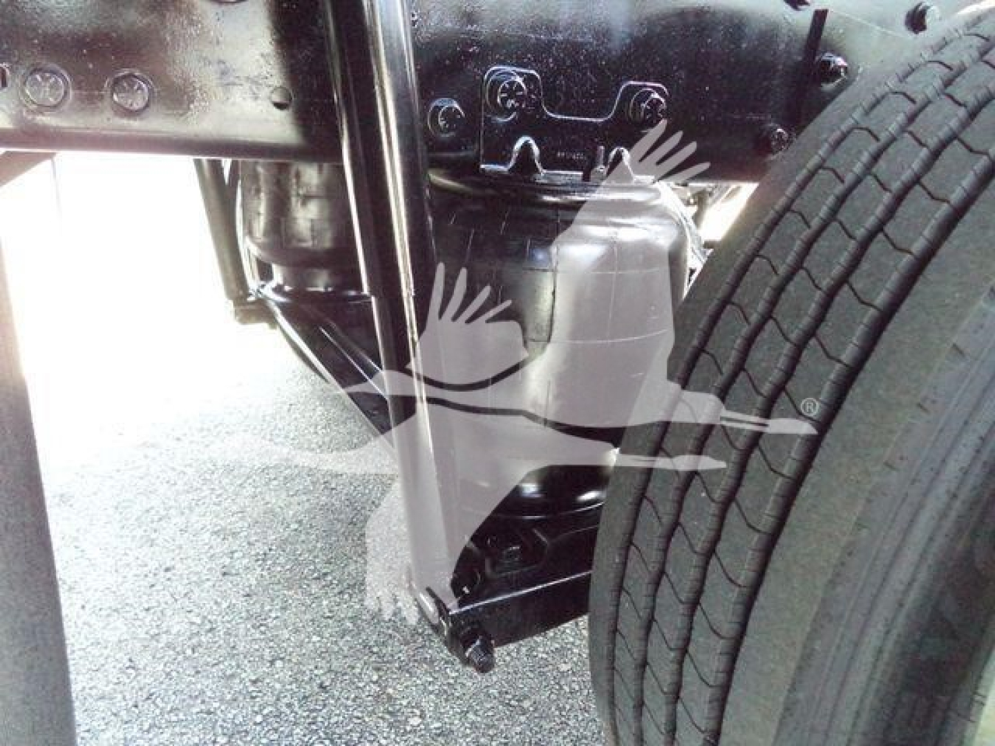 Hino 268A undercarriage showing chassis frame and front suspension components near the front wheel