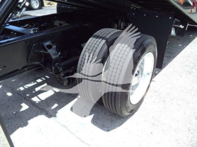 Truck rear dual tires and undercarriage of a 2020 Hino 268A rollback truck showing dual rear wheels and chassis components.