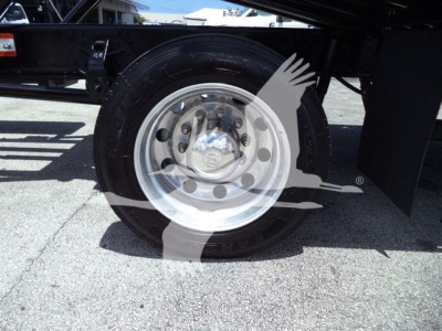 Truck rear wheel showing polished steel rim and tire on a Hino 268A rollback truck with stock number T75219FM.