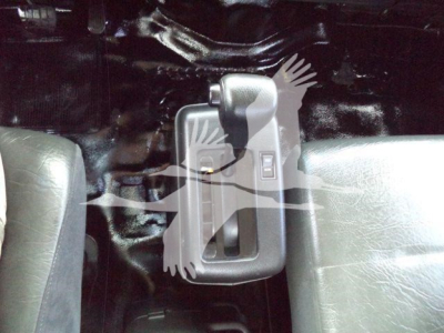 Cab interior showing a console-mounted window crank and door handle on the passenger side of a 2020 Hino 268A rollback truck.