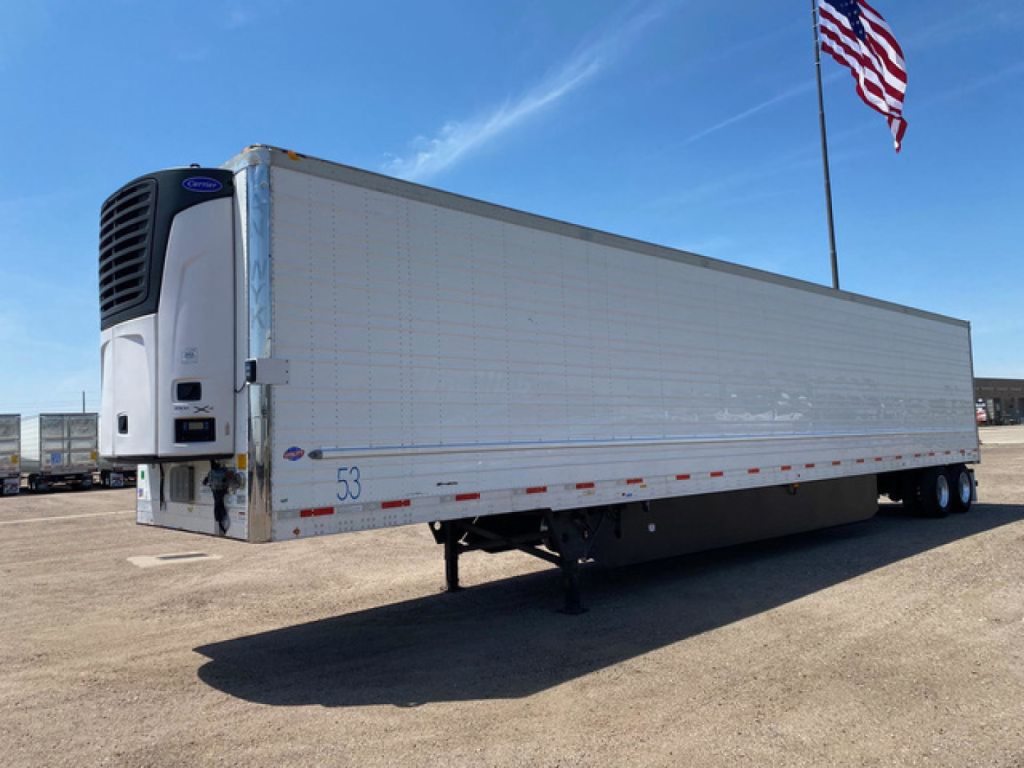 Trailer front-left view of a 2021 Utility reefer trailer showing refrigeration unit and side paneling with stock number 53.