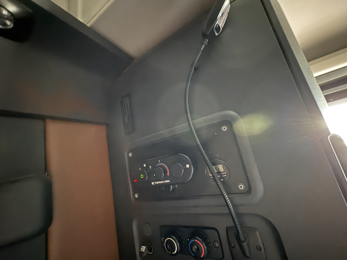 Cab interior of a 2022 Freightliner Cascadia 126 showing the dashboard control panel with gauges and a microphone.
