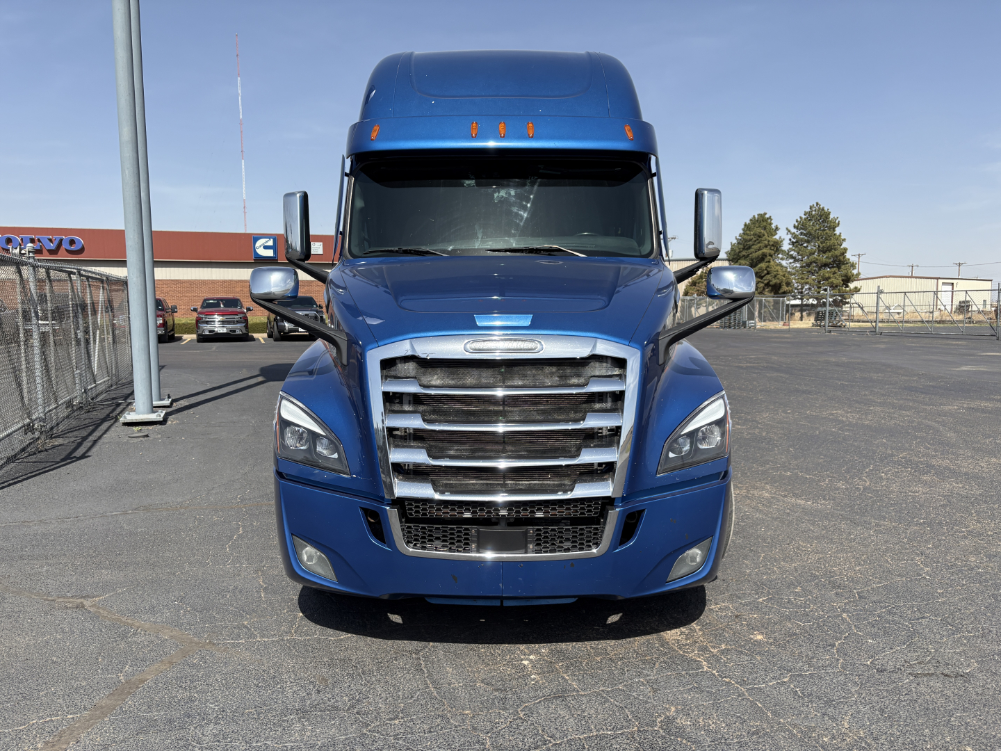 Front view of a blue 2022 Freightliner Cascadia 126 conventional sleeper truck, chrome grille, large bumper, dual side mirrors.