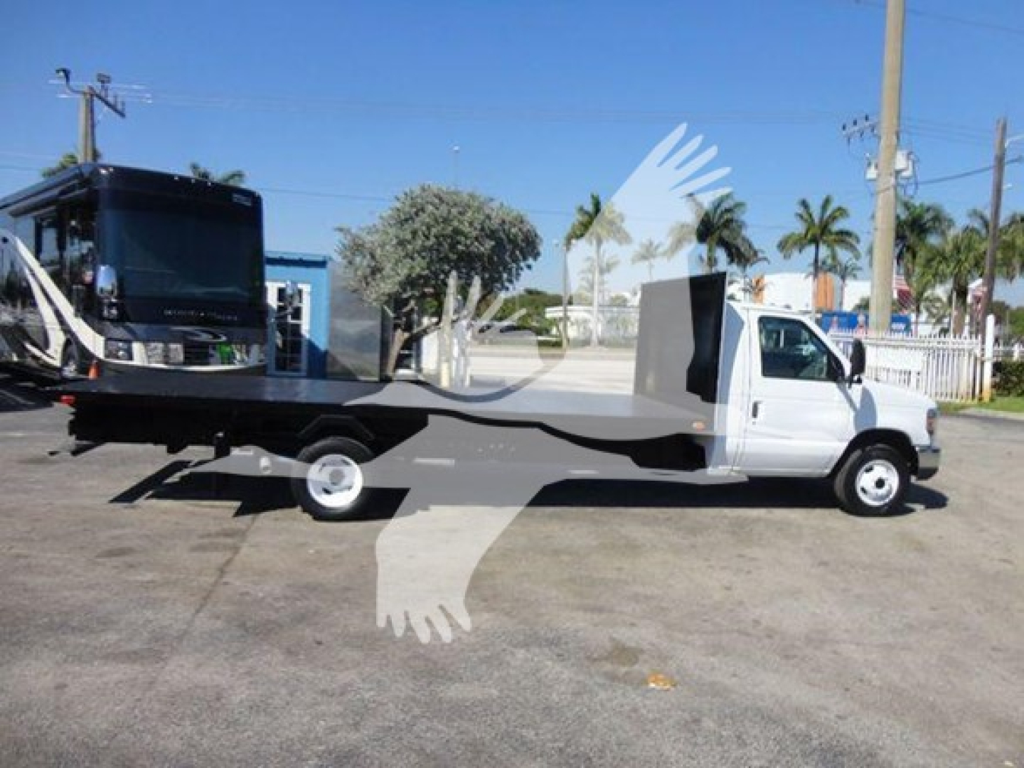 Flatbed tow truck with a white cab and long black flatbed; VIN 1FDXE4FS3BDB20639 and stock number T20639 visible on the image.