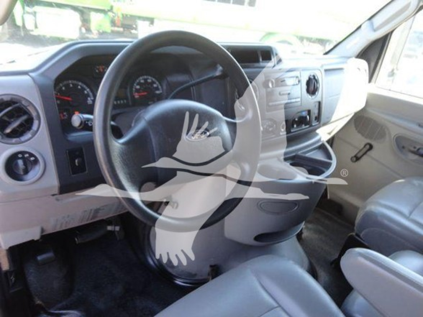 Ford E-450 interior showing steering wheel and dashboard with center console and driver seat.