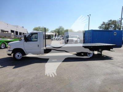 Flatbed tow truck, 2011 Ford E450, side view showing long flatbed bed and standard cab, VIN 1FDXE4FS3BDB20639 on vehicle listing.