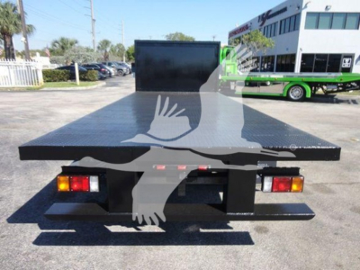 Flatbed truck bed with large aluminum platform and rear lights visible.