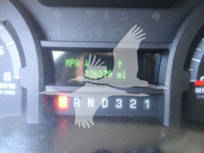 Gauge cluster showing low-resolution digital display with MPG and odometer 106,07? mi, gear selector R N D 3 2 1, small warning light illuminated.