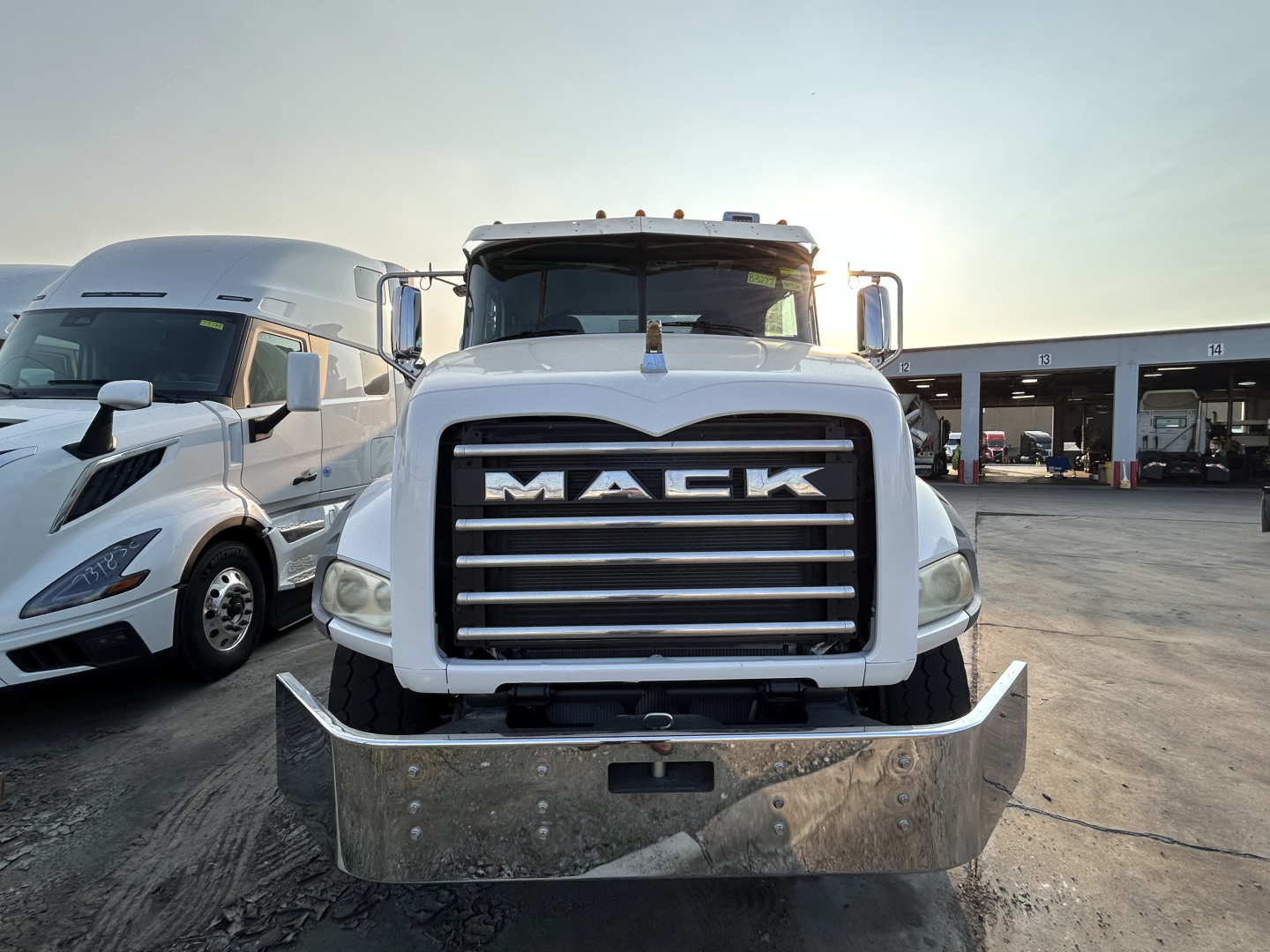 Front view of a white 2020 Mack GR64B mixer truck with large chrome grille, bumper guard, and dual side mirrors.
