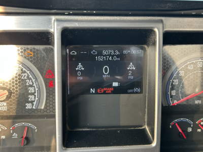 Dashboard center display shows 5073.3h, 85°F, 06:57, odometer 152174.0mi, multiple gauges with N gear indicator, brake air warning, and digital readouts for psi.